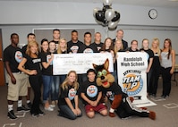 The San Antonio Spurs representives presents a $20,000 check to the Randolph High School Student Council April 13. The student council was selected for their DriveSMART campaign by the Silver and Black Give Back’s Team Up Challenge. (U.S. Air Force photo by Melissa Peterson)