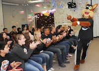 The San Antonio Spurs mascot shoots confetti into a crowd of students at Randolph High School April 13. The student council was selected for their DriveSMART campaign by the Silver and Black Give Back’s Team Up Challenge. (U.S. Air Force photo by Melissa Peterson)