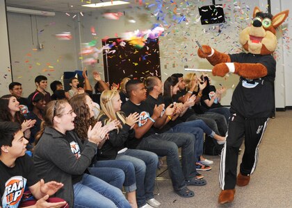 The San Antonio Spurs mascot shoots confetti into a crowd of students at Randolph High School April 13. The student council was selected for their DriveSMART campaign by the Silver and Black Give Back’s Team Up Challenge. (U.S. Air Force photo by Melissa Peterson)