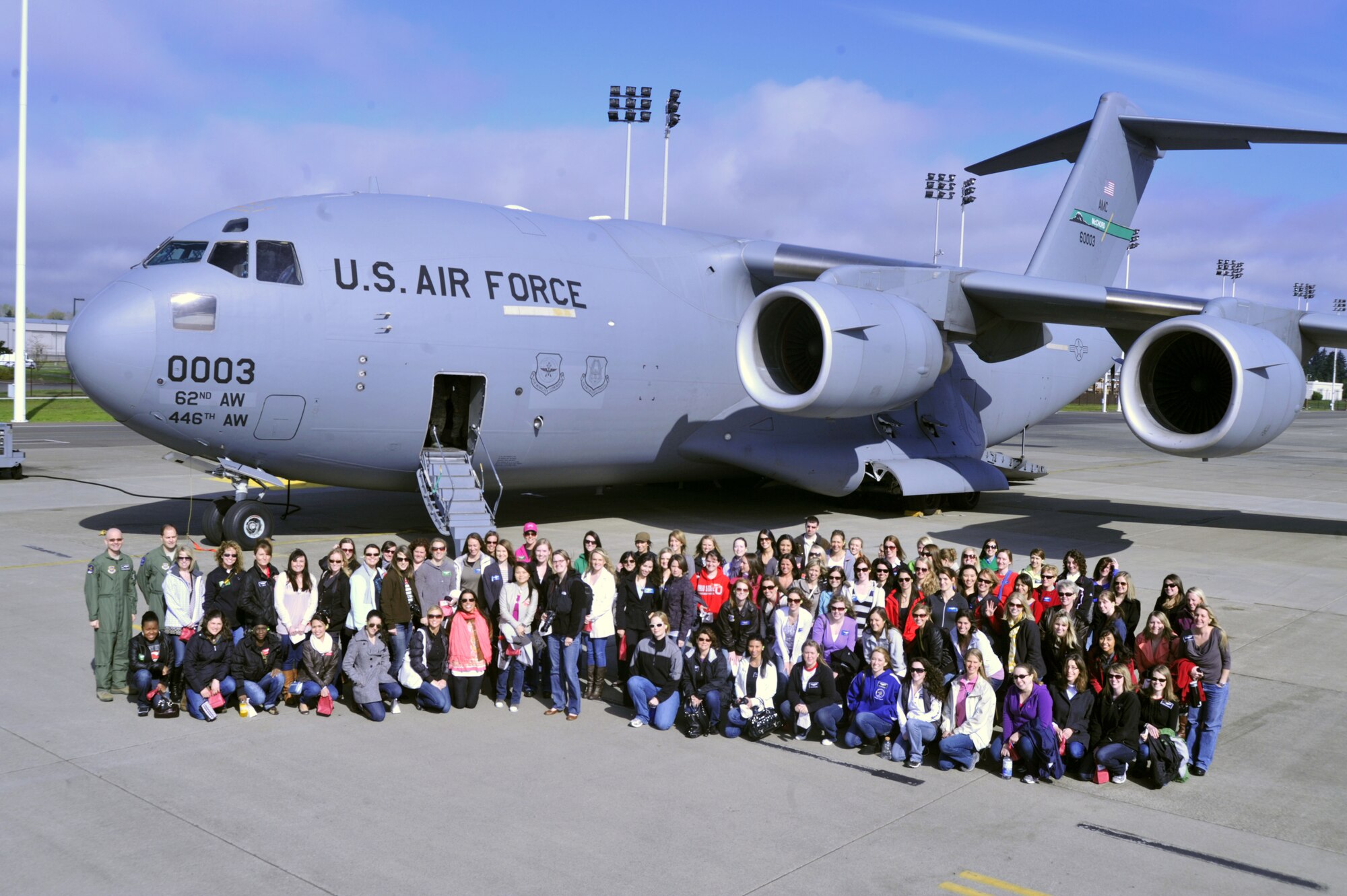 More than 100 spouses of the 62nd Operations Group stand together for a group photograph prior to flying on a C-17 Globemaster III April 14, 2012, at Joint Base Lewis-McChord, Wash. The 62nd OG hosted an orientation flight to show appreciation for their spouses. (U.S. Air Force photo/Staff Sgt. Frances Kriss)