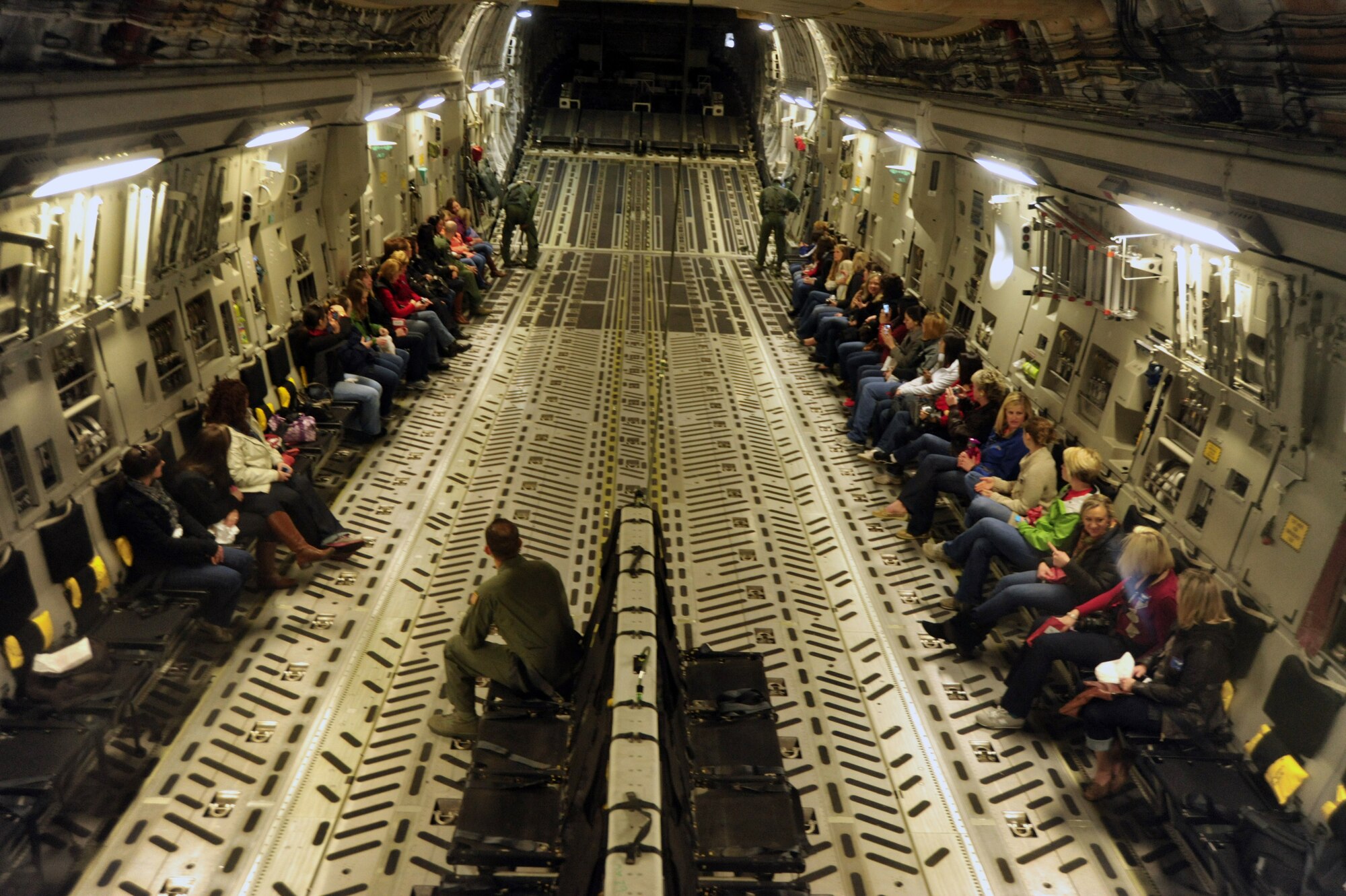 Spouses of the 62nd Operations Group wait as loadmasters prepare to lower the ramp door of a C-17 Globemaster III April 14, 2012, at Joint Base Lewis-McChord, Wash. The spouses had an opportunity to get an overhead view of Mt. Rainier and the Washington state coastline. (U.S. Air Force photo/Staff Sgt. Frances Kriss)