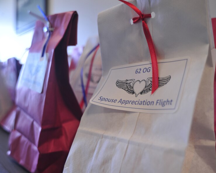Spouses of the 62nd Operations Group were given goodie bags containing ear plugs and motion sickness bags prior to flying on a C-17 Globemaster III April 14, 2012, at Joint Base Lewis-McChord, Wash. The 62nd OG hosted an orientation flight to show appreciation for their spouses. (U.S. Air Force photo/Staff Sgt. Frances Kriss)