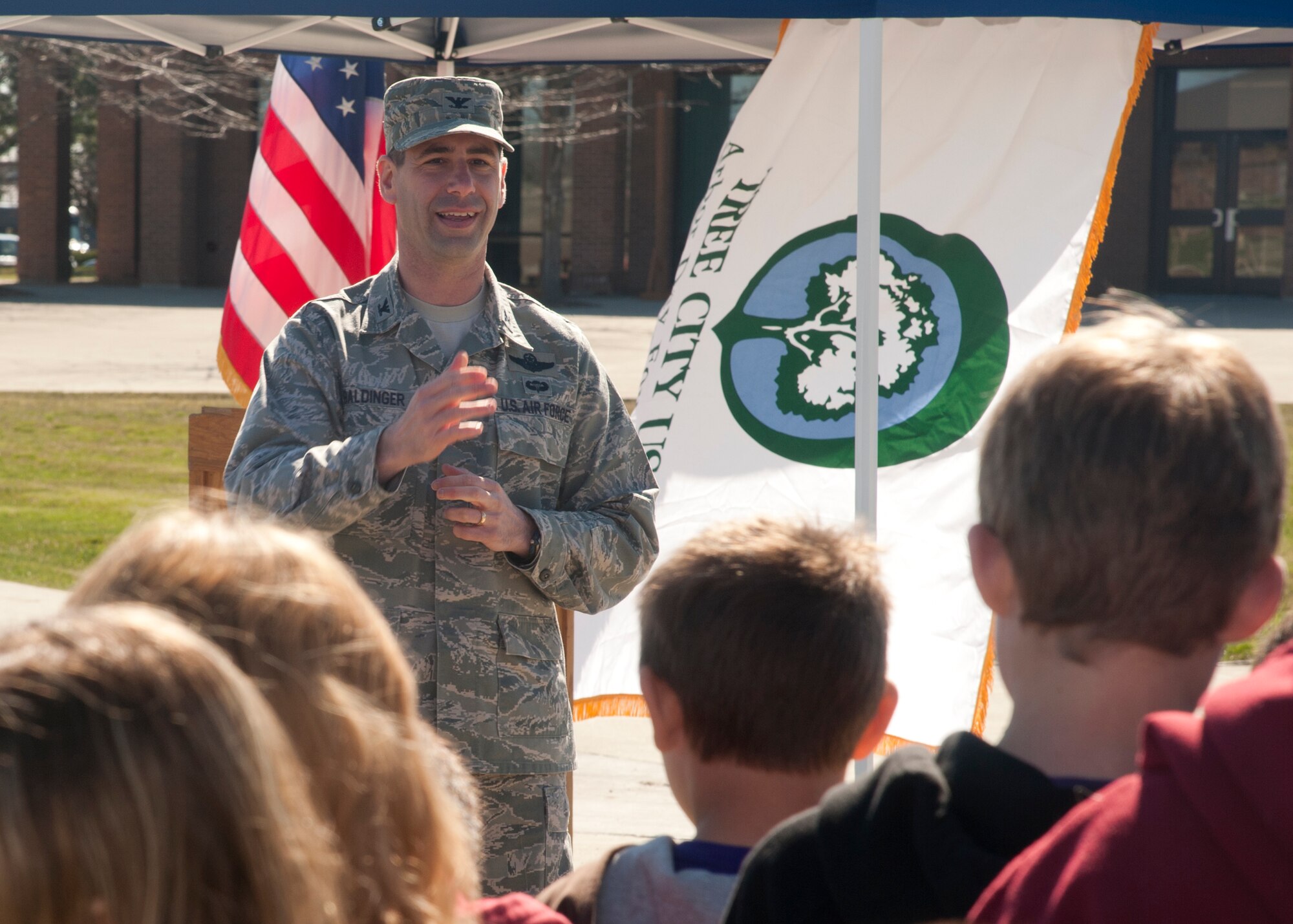 Col. Ronald Baldinger, 336th Training Group commander, speaks to students from Michael Anderson Elementary School during the Arbor Day celebration at Fairchild Air Force Base, Wash., April 13, 2012. More than 30 students from the elementary school came out to help the base celebrate the holiday. (U.S. Air Force photo by Staff Sgt. Michael Means/Released)