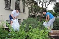 Senior Master Sgt. Annette Reid (left) and Master Sgt. Gabriela Jaramillo, Air Education and Training Command medical services and training, pull weeds around Bldg. 671 on Joint Base San Antonio-Randolph April 12. The unit was out landscaping the building during "I Love Randolph " week. (U.S. Air Force photo/Rich McFadden) 