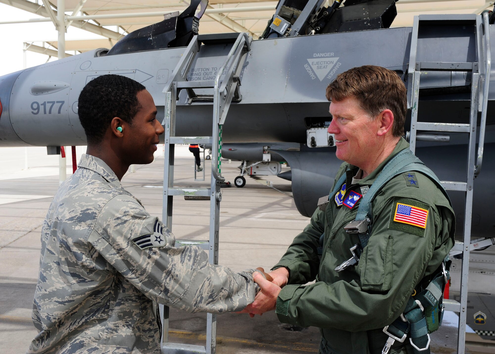 Maj. Gen. Mike Skinner, Mobilization Assistant, Air Education and Training Command, was able to see many aspects of Luke Air Force Base's missions when he visited the base April 5-6. Getting his first ride in an F-16 was a highlight according to the general, who used the opportunity to thank Luke's Airmen for their hard work.

"Don't let rank get in our way," the general told Senior Airman Dominique Wilson, F-16 Dedicated Crew Chief, 308th Aircraft Maintenance Unit. "I'm not familiar with this jet, so if you see me do something unsafe, call me out on it." 

The general was safely strapped in and briefed by Airman Wilson, who was thanked officially after the flight, by receiving the general's coin. (U.S. Air Force Photo by Staff Sgt. Jason Colbert) 