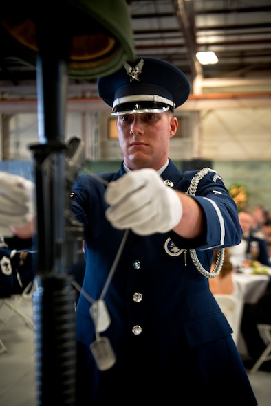 U.S. Air Force Airman 1st Class Christopher Shaw, Moody Air Force Base Honor Guard member, places dog tags to a memorial during a fallen warriors tribute at the 347th Rescue Group Rescue Warrior Ball at Moody Air Force Base, Ga., April 13, 2012. The tribute honored Service members, past and present, who made the ultimate sacrifice in defense of their country. (U.S. Air Force photo by Staff Sgt. Jamal D. Sutter/Released) 
