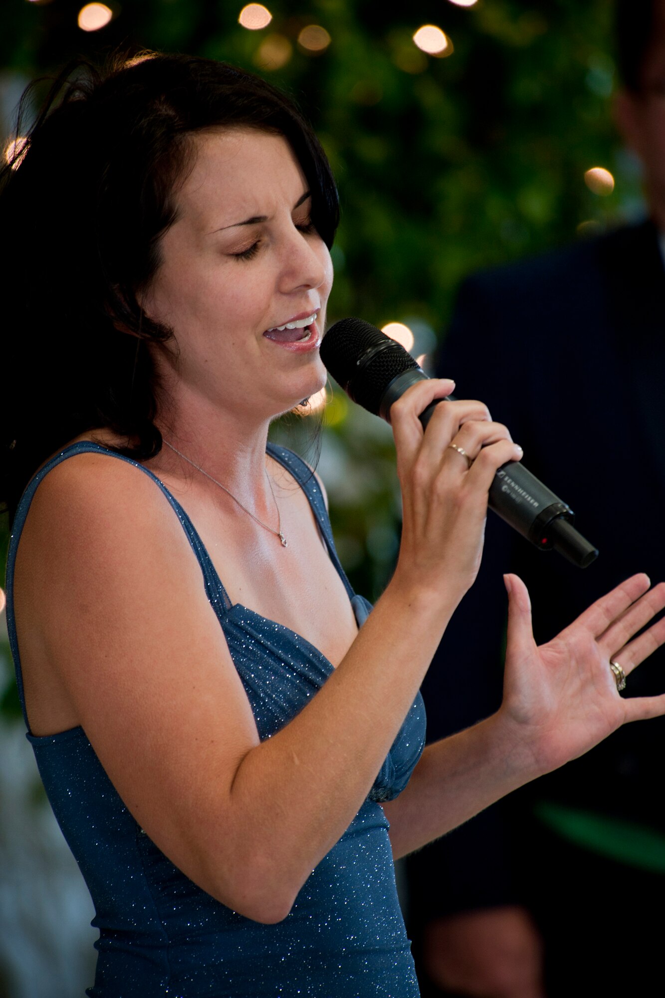 Tamara Wineland, wife of U.S. Air Force Capt. Edward Wineland, 71st Rescue Squadron, sings the national anthem during the 347th Rescue Group Rescue Warrior Ball at Moody Air Force Base, Ga., April 13, 2012. Members of the 347th RQG gathered to celebrate and honor the accomplishments of their rescue warriors and families. (U.S. Air Force photo by Staff Sgt. Jamal D. Sutter/Released)