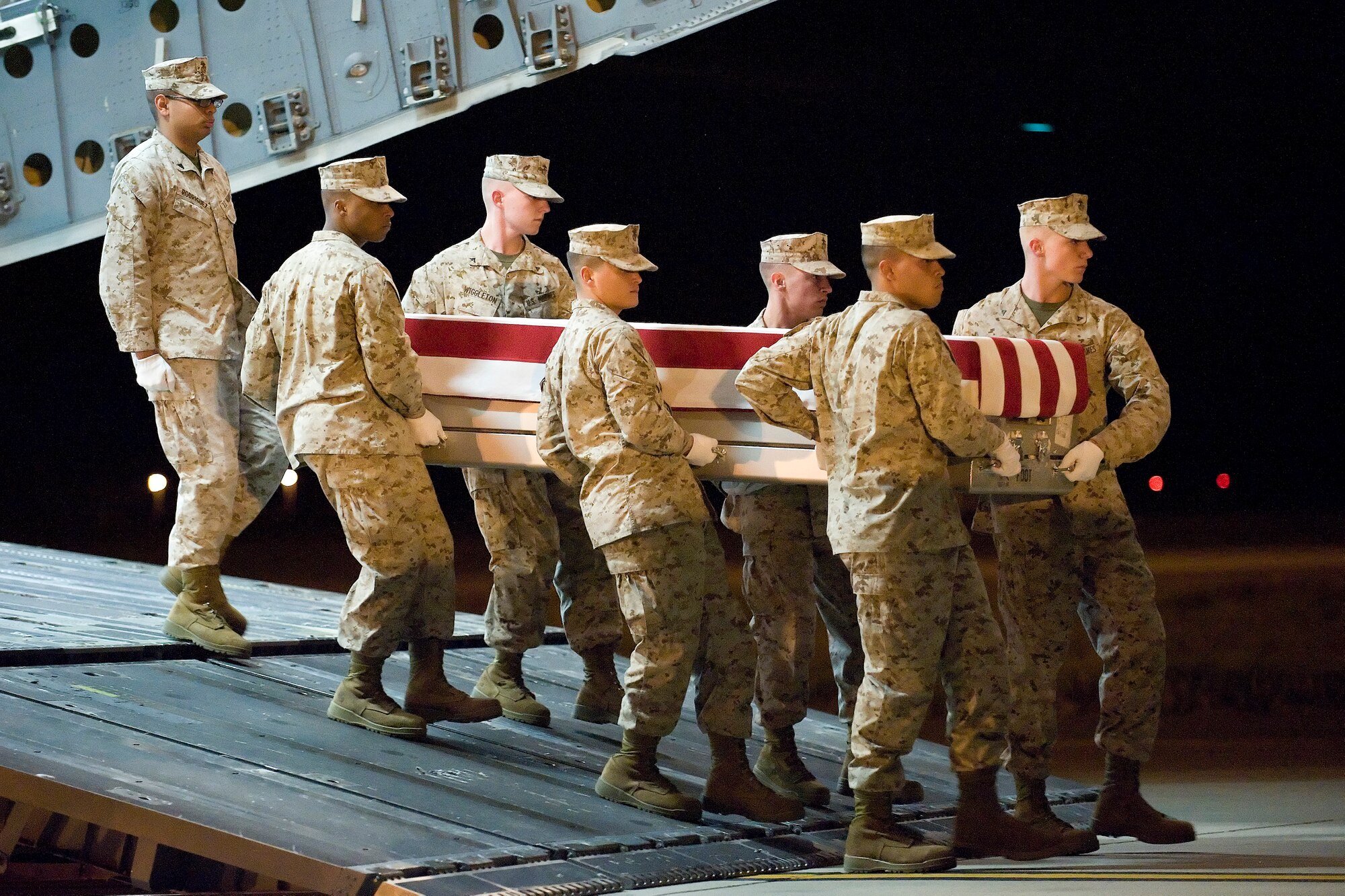 A U.S. Marine Corps carry team transfers the remains of Lance Cpl. Abraham Tarwoe of Providence, R.I., at Dover Air Force Base, Del., April 16, 2012. Tarwoe was assigned to the 2nd Battalion, 9th Marine Regiment, 2nd Marine Division, II Marine Expeditionary Force, Camp Lejeune, N.C. (U.S. Air Force photo/Adrian R. Rowan)
