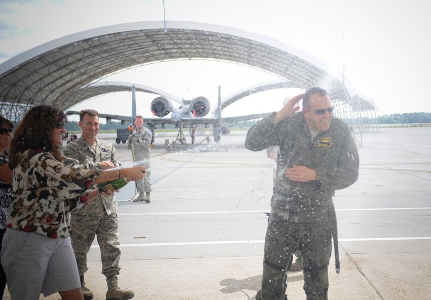 U.S. Air Force Col. Christopher Short, 23d Wing vice commander, is sprayed by family and friends after his fini-flight at Moody Air Force Base, Ga., April 13, 2012. The fini-flight is a long-standing Air Force tradition that occurs when a pilots departs from the base. (U.S. Air Force photo by Airman 1st Class Douglas Ellis/Released)