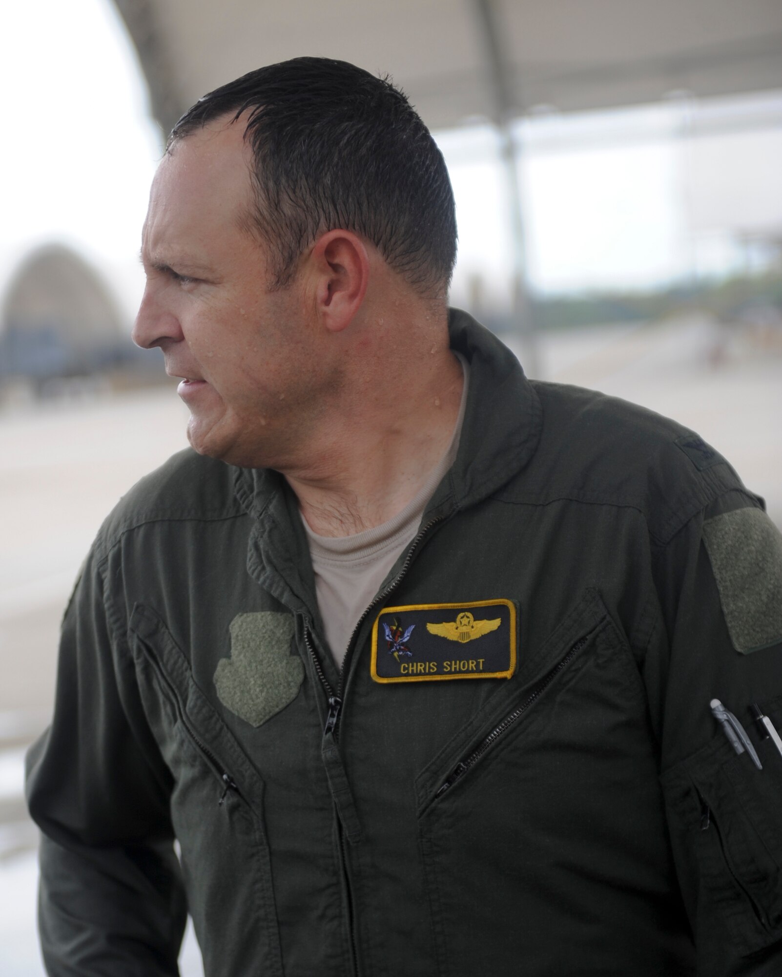 U.S. Air Force Col. Christopher Short, 23d Wing vice commander, stands at the flightline covered in water and champagne after returning from his fini-flight at Moody Air Force Base, Ga., April 13, 2012. After departing Moody, Short will assume command of the 366th Fighter Wing at Mountain Home Air Force Base, Idaho. (U.S. Air Force photo by Airman 1st Class Douglas Ellis/Released)
