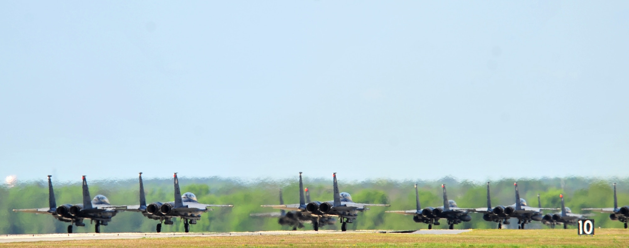 F-15E Strike Eagles of the 4th Fighter Wing perform an "Elephant Walk" as they taxi down the runway during a Turkey Shoot training mission on Seymour Johnson Air Force Base, N.C., April 16, 2012. The wing generated nearly 70 aircraft to destroy more than 1,000 targets on bombing ranges across the state to commemorate the 4th’s victory over the Luftwaffe on April 16, 1945. The aircrews are assigned to the 4th Fighter Wing’s 333rd, 334th, 335th, and 336th Fighter Squadrons. (U.S. Air Force photo/Staff Sgt. Makenzie Lang/Released)