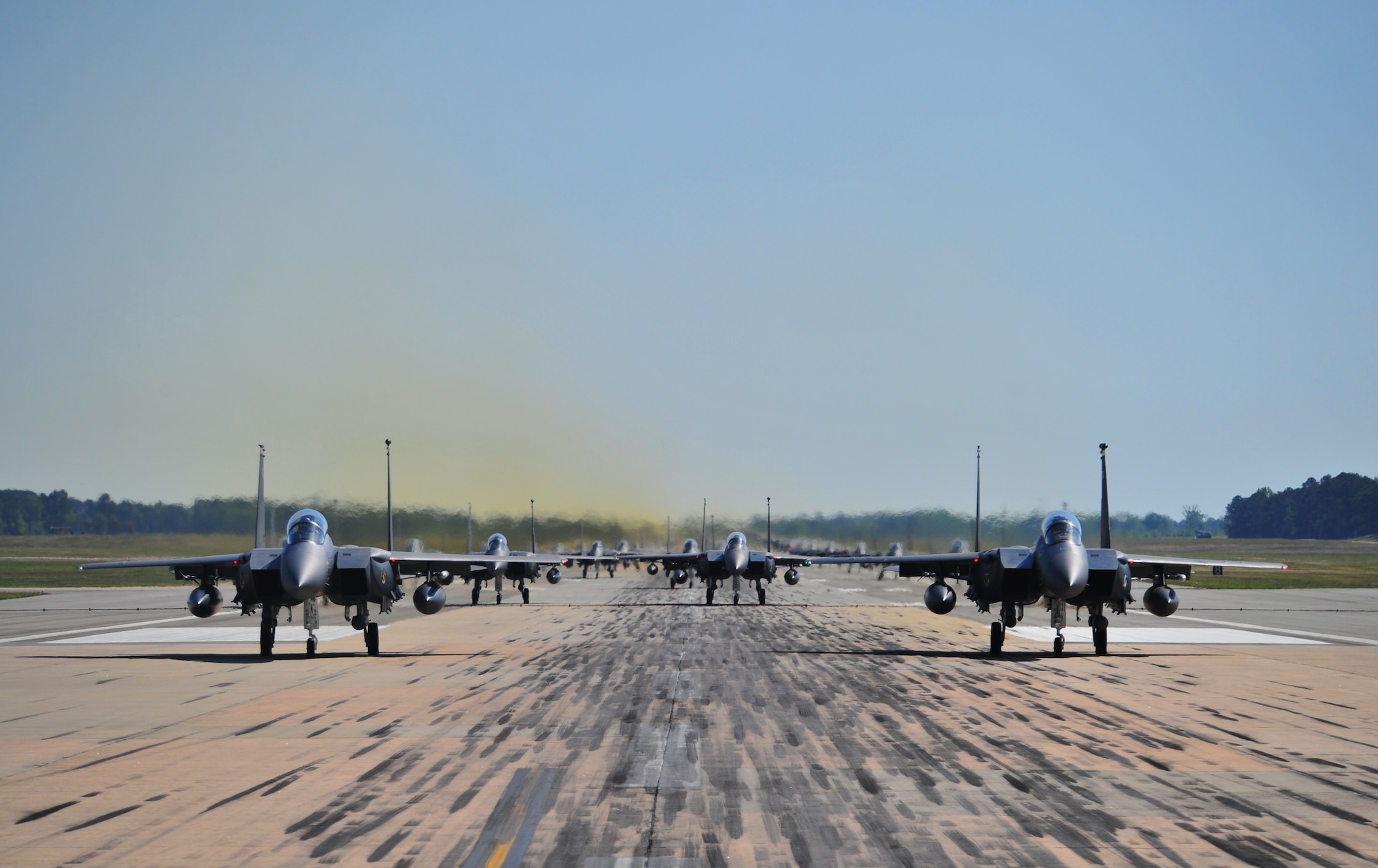F-15E Strike Eagles of the 4th Fighter Wing perform an "Elephant Walk" as they taxi down the runway during a Turkey Shoot training mission on Seymour Johnson Air Force Base, N.C., April 16, 2012. The wing generated nearly 70 aircraft to destroy more than 1,000 targets on bombing ranges across the state to commemorate the 4th's victory over the Luftwaffe on April 16, 1945. The aircrews are assigned to the 4th Fighter Wing's 333rd, 334th, 335th, and 336th Fighter Squadrons.  (U.S. Air Force photo/Staff Sgt. Elizabeth Rissmiller/Released)