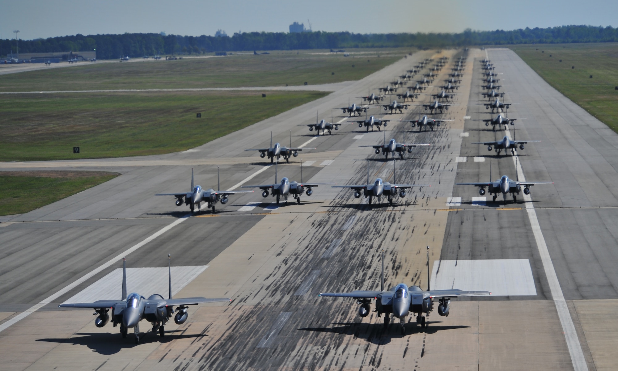 F-15E Strike Eagles of the 4th Fighter Wing perform an "Elephant Walk" as they taxi down the runway during a Turkey Shoot training mission on Seymour Johnson Air Force Base, N.C., April 16, 2012. The wing generated nearly 70 aircraft to destroy more than 1,000 targets on bombing ranges across the state to commemorate the 4th's victory over the Luftwaffe on April 16, 1945. The aircrews are assigned to the 4th Fighter Wing's 333rd, 334th, 335th, and 336th Fighter Squadrons.  (U.S. Air Force photo/Staff Sgt. Elizabeth Rissmiller/Released)