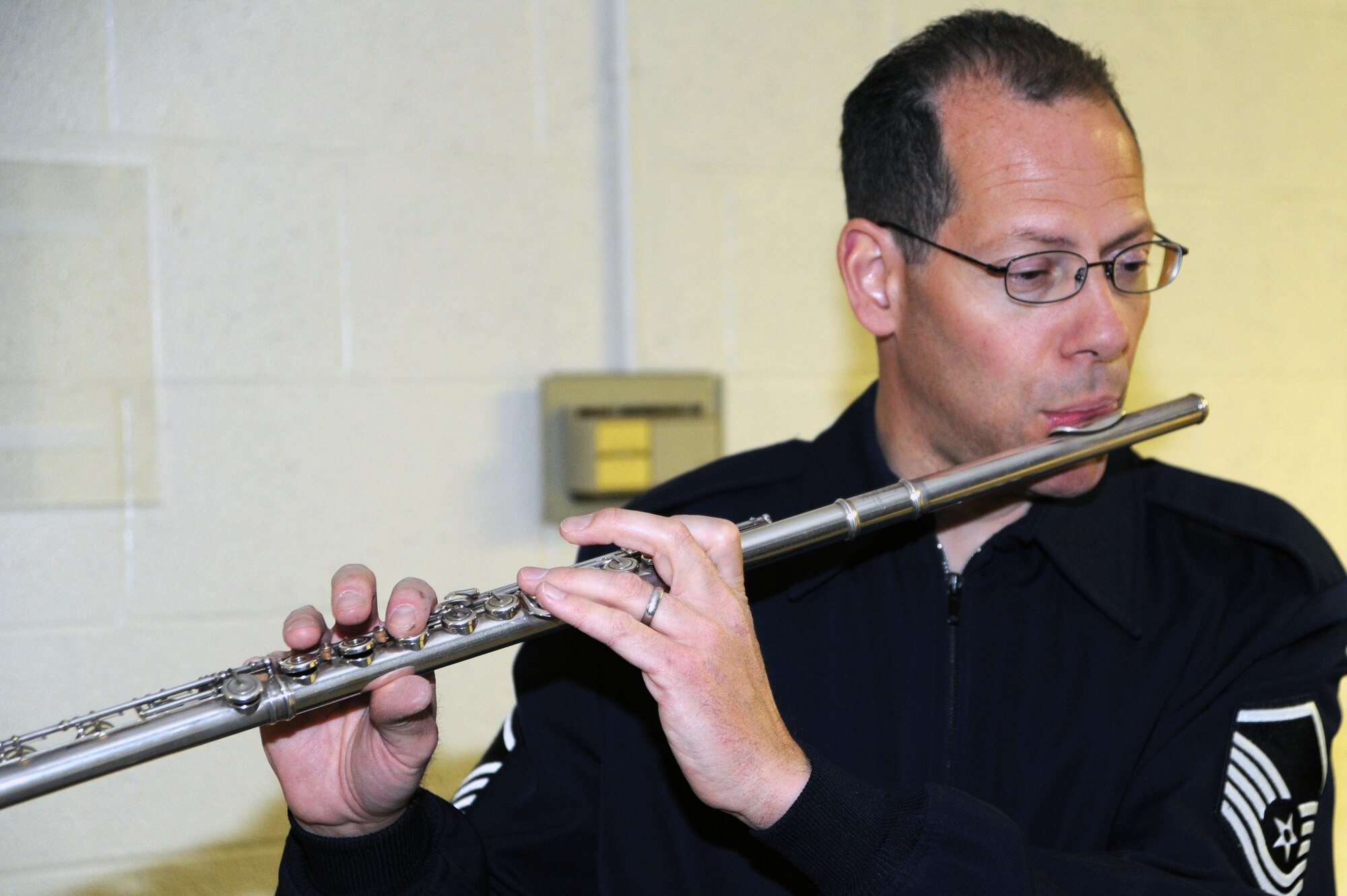 Master Sgt. Andy Axelrad, second alto saxophone player with The USAF Band’s premier jazz ensemble Airmen of Note, warms up his flute before a concert at Willett Hall in Portsmouth, Va., April 12. (U.S. Air Force photo by Lynda Valentine)
 
