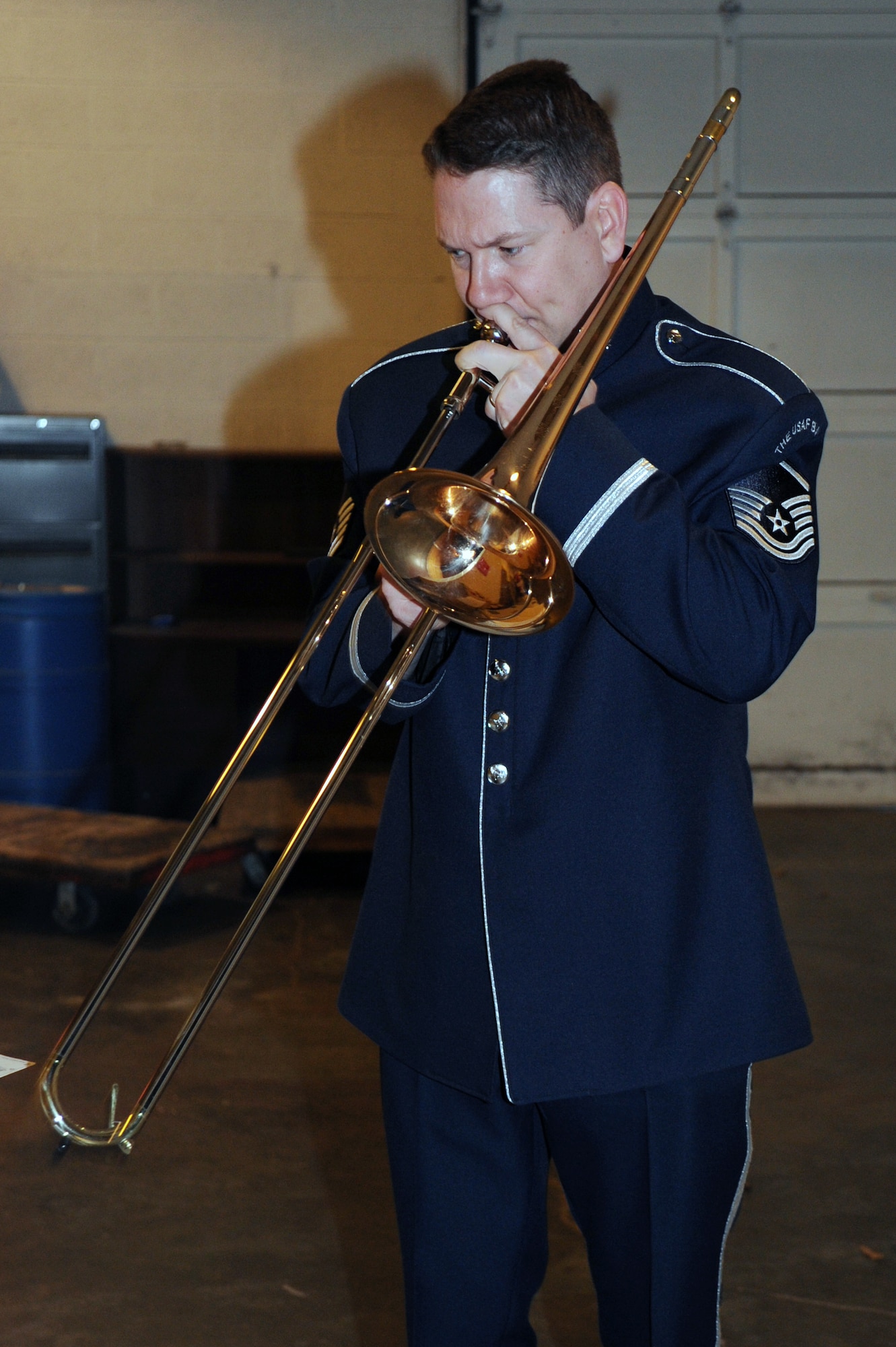 Airmen of Note trombone player Master Sgt. Ben Patterson finds a quiet place to rehearse on the loading docks at Willett Hall in Portsmouth, Va., April 12. The Airmen of Note are on an 18-concert tour throughout Virginia, North Carolina, South Carolina and Georgia. Patterson is not only a musician with the ensemble, he is also the lead tour planner. (U.S. Air Force photo by Lynda Valentine)