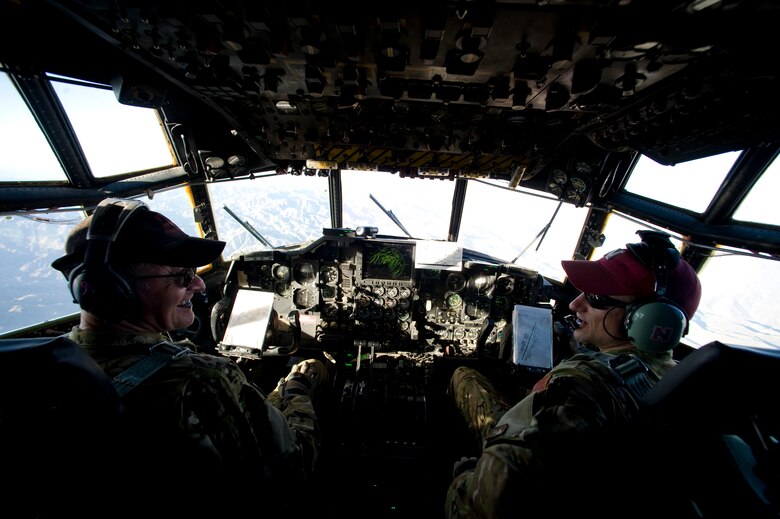 CAMP BASTION, Afghanistan -- U.S. Air Force Lt. Col. James Routt an HC-130P pilot with the 550th Special Operations Squadron and Capt. Phillip Varilek with the 71st Expeditionary Rescue Squadron, talk during the last combat mission of Routt's career, Camp Bastion, Afghanistan, April 12, 2012. Routt is currently the oldest active pilot in the Air Force and is augmenting for the 71st Expeditionary Rescue Squadron. The mission of the 71st ERQS is to provide personnel recovery, casualty evacuation and aeromedical evacuation assets to hostile locations. The 71st ERQS is the only fixed wing aircraft squadron dedicated to medical evacuation missions in Afghanistan. (Photo by Staff Sgt. Greg Biondo)