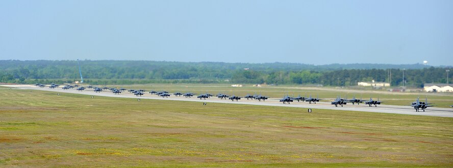 F-15E Strike Eagles of the 4th Fighter Wing perform an "Elephant Walk" as they taxi down the runway during a Turkey Shoot training mission on Seymour Johnson Air Force Base, N.C., April 16, 2012. The wing generated nearly 70 aircraft to destroy more than 1,000 targets on bombing ranges across the state to commemorate the 4th’s victory over the Luftwaffe on April 16, 1945. The aircrews are assigned to the 4th Fighter Wing’s 333rd, 334th, 335th, and 336th Fighter Squadrons.  (U.S. Air Force photo/Senior Airman Gino Reyes/Released)