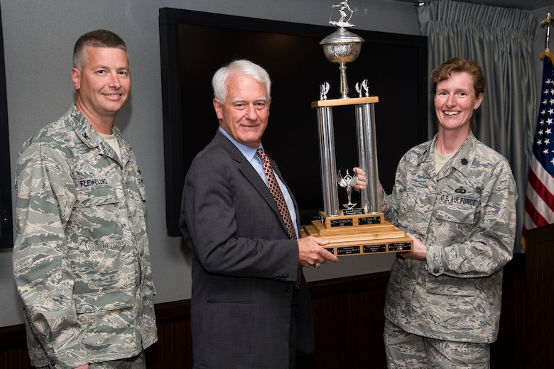 Col. Jeffrey Flewelling (left), 21st Space Wing vice commander, accepts the Snofest trophy on behalf of Peterson AFB from Lt. Col. Ann Igl, 21st Force Support Squadron commander, and Bill Gessner, Special Assistant to the Chief of Staff for Command Support, NORAD/USNORTHCOM, April 11 in the 21st SW conference room. This was the fourth year in a row that Peterson AFB walked away with the commander's cup. The annual Snofest event was held in January at Keystone, Colo., and featured special lodging deals, discounted lift tickets, ski and snowboard races, wine and beer tastings, sleigh rides, gondola rides, live music and more. (U.S. Air Force photo/Craig Denton)