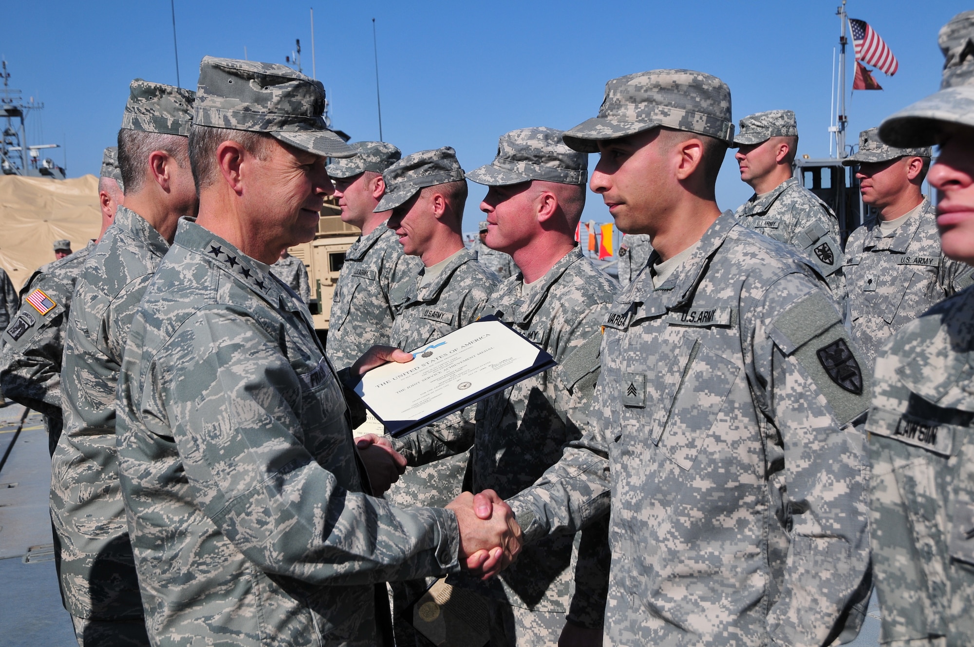 U.S. Air Force Gen. William Fraser, left, head of the U.S. Transportation Command, presents U.S. Army Sgt. Jovanny Vargas, a watercraft operator with the 331st Transportation Company (Modular Causeway System), 24th Transportation Battalion, 7th Sustainment Brigade, with a Joint Service Achievement Medal during a ceremony held on Fort Eustis’ 3rd Port, April 9. The “Causeway or No Way” company was recognized for their role in Operation Deep Freeze, a yearly operation to support the science and research activities conducted by the U.S. Antarctic Program. (U.S. Army photo by Sgt. Edwin Rodriguez/Released)
