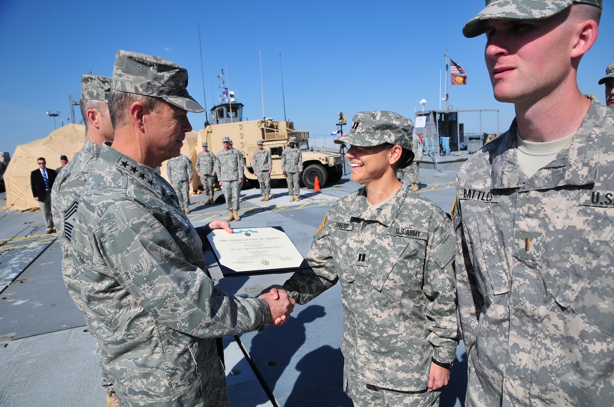 U.S. Air Force Gen. William Fraser, left, head of the U.S. Transportation Command, presents U.S. Army Capt. Christina Shelton, commander of the 331st Transportation Company (Modular Causeway System), 24th Transportation Battalion, 7th Sustainment Brigade, with a Joint Service Achievement Medal during a ceremony held on Fort Eustis’ 3rd Port, April 9. She was in command of the 42 soldiers who embarked to Antarctica in support of Operation Deep Freeze. (U.S. Army photo by Sgt. Edwin Rodriguez/Released)