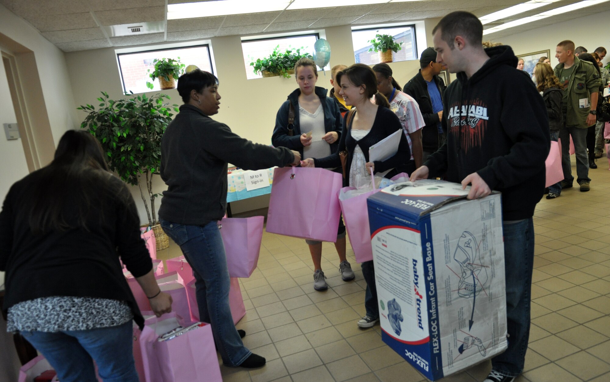Senior Airman Kim McCreery, 375th Medical Support Squadron lab technician, and her husband John, were one of 85 families to receive about $150 worth of items including a car seat, diapers and other baby necessities during the Expecting Parents Baby Shower April 14 at Chapel 1. The shower was hosted by the Airman and Family Readiness Center, New Parent Support Program, Operation Homefront and American Red Cross. (U.S. Air Force photo by Senior Airman Amber R. Kelly-Herard) 