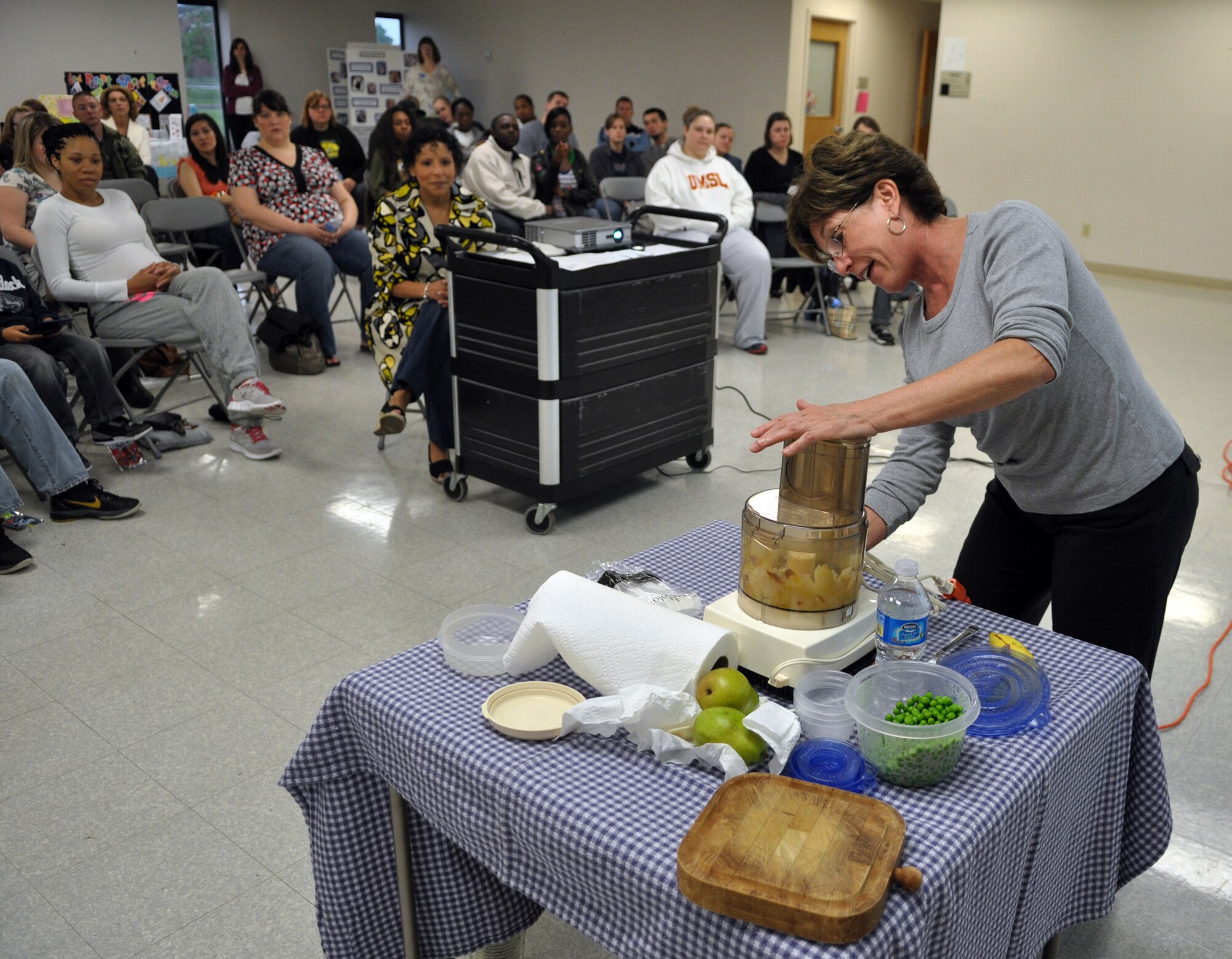 Kathy Wein, 375th Medical Support Squadron nutritionist, demonstrates how to make homemade baby food during the Expecting Parents Baby Shower held April 14 at Chapel 1. Other topics covered during the baby shower were infant CPR and baby sign language. (U.S. Air Force photo by Senior Airman Amber R. Kelly-Herard)