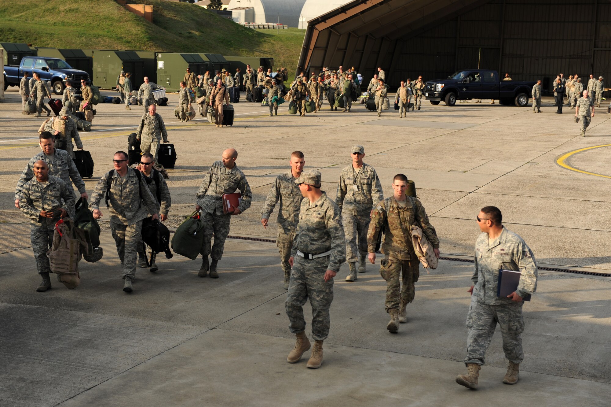 SPANGDAHLEM AIR BASE, Germany – Airmen from the 52nd Fighter Wing walk towards their friends and families after a customs inspection on Ramp 3 here April 13. Family and friends waited at Hangar 3 to welcome home more than 70 Airmen from a deployment with 81st Fighter Squadron to Bagram Airfield, Afghanistan, who had been providing close-air support during Operation Enduring Freedom. (U.S. Air Force photo by Airman 1st Class Matthew B. Fredericks/Released)