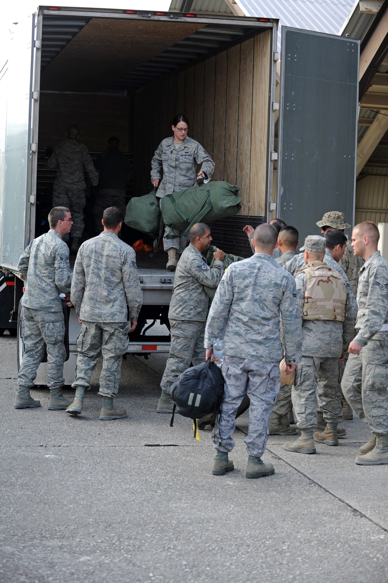 SPANGDAHLEM AIR BASE, Germany – Airmen from the 52nd Fighter Wing unload baggage in preparation for a customs inspection on Ramp 3 here April 13. Family and friends waited at Hangar 3 to welcome home more than 70 Airmen from a deployment with 81st Fighter Squadron to Bagram Airfield, Afghanistan, who had been providing close-air support during Operation Enduring Freedom. (U.S. Air Force photo by Airman 1st Class Matthew B. Fredericks/Released)