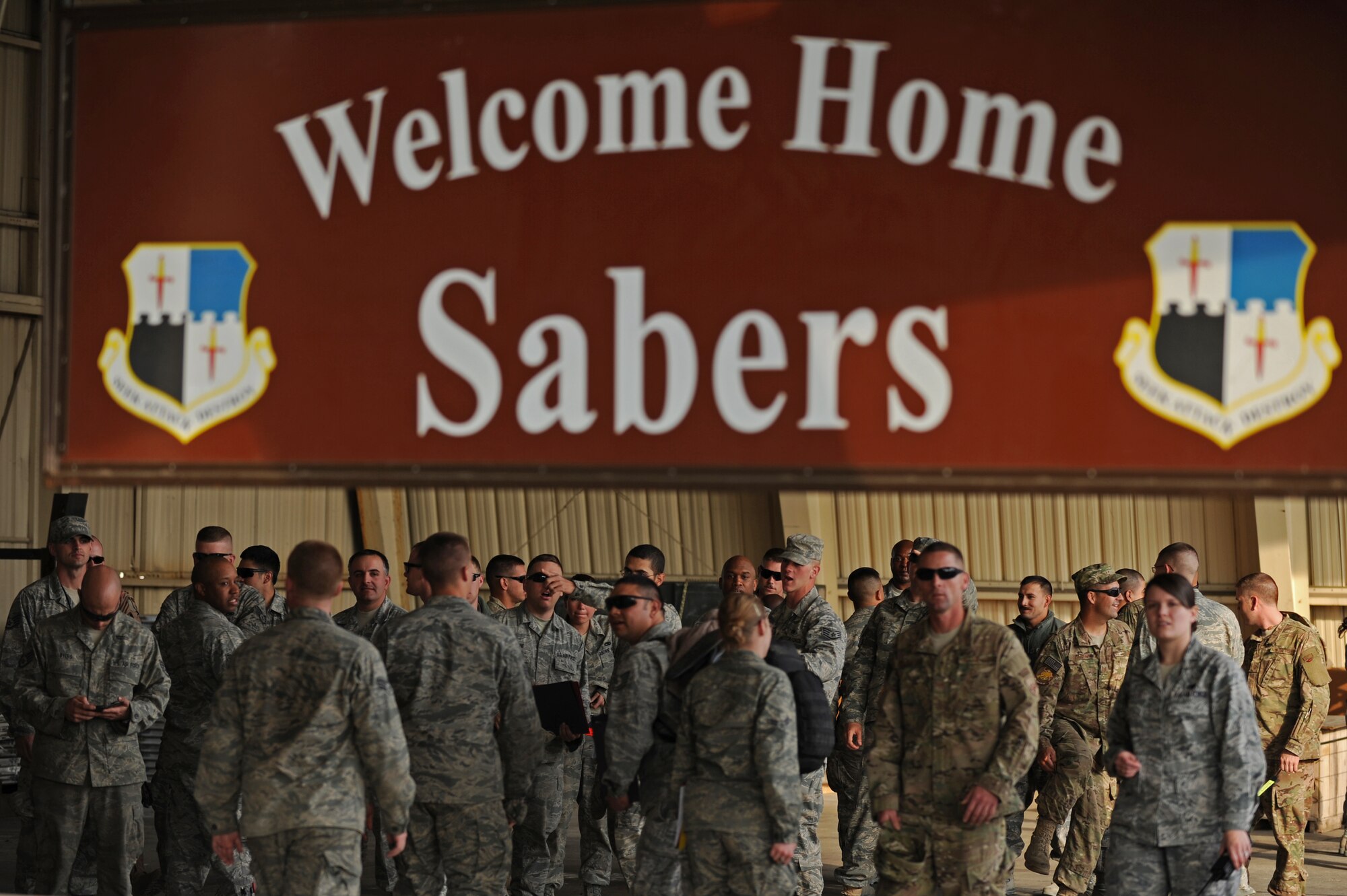 SPANGDAHLEM AIR BASE, Germany – Airmen from the 52nd Fighter Wing wait to process through customs on Ramp 3 here April 13. Family and friends waited at Hangar 3 to welcome home more than 70 Airmen from a deployment with 81st Fighter Squadron to Bagram Airfield, Afghanistan, who had been providing close-air support during Operation Enduring Freedom. (U.S. Air Force photo by Airman 1st Class Matthew B. Fredericks/Released)