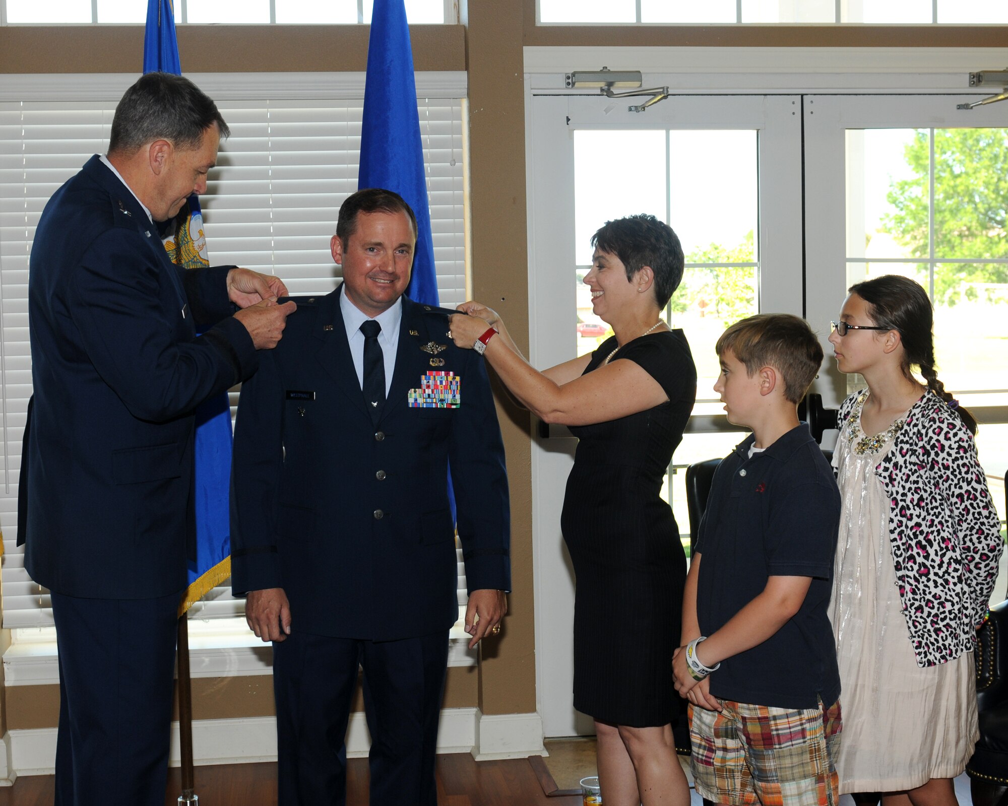 Col. Johann Westphall, 14th Medical Group waits as Brig. Gen. Kory Cornum and his wife pin the rank of colonel onto his uniform during a ceremony on April 8. (U.S. Air Force photo)