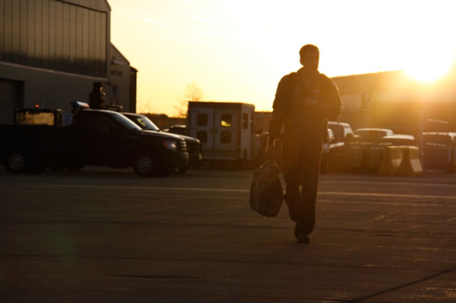 Capt. Scott Cook, a C-130 pilot attached to the 758th Airlift Squadron at the 911th Airlift Wing, walks onto the flightline toward a C-130 Hercules at early sunrise, April 14, 2012. Approximately 40 Airmen are departing for the last cycle of a two week mission in support of `Coronet Oak’ operations based out of the Air National Guard Base, Muniz, Puerto Rico. (U.S. Air Force photo/Airman 1st Class Justyne Obeldobel/Released)