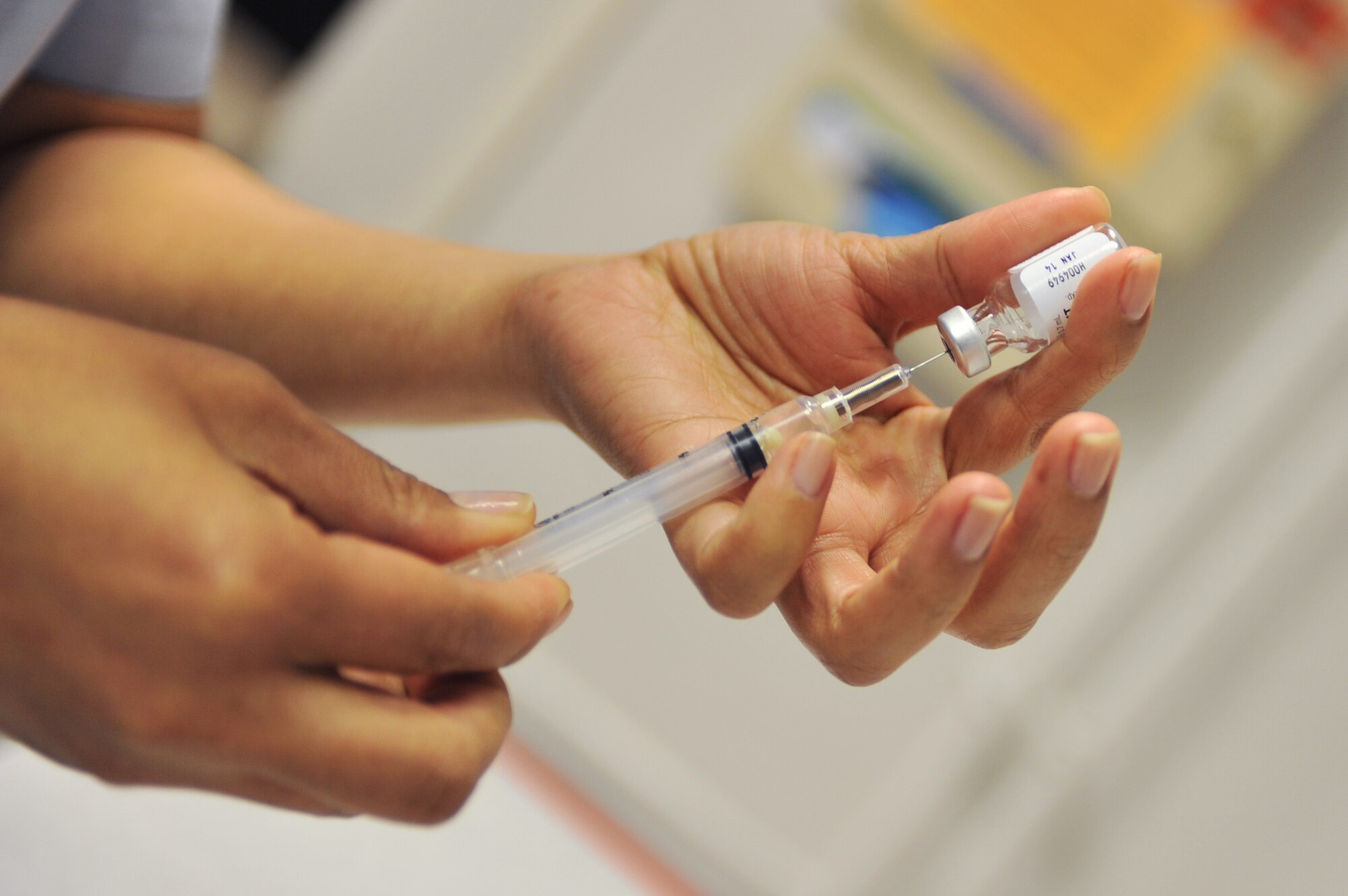 Staff Sgt. Glenda Castillo, 86th Medical Basic Life Support Program director, prepares an influenza vaccine in the immunization section of the clinic on Ramstein Air Base, Germany, April 16, 2012. As an Air Force Smart Operations of the 21st Century initiative, the implemented changes allow clinic staff to work more efficiently and better serve customers. (U.S. Air Force photo by Airman 1st Class Caitlin O'Neil-McKeown)  