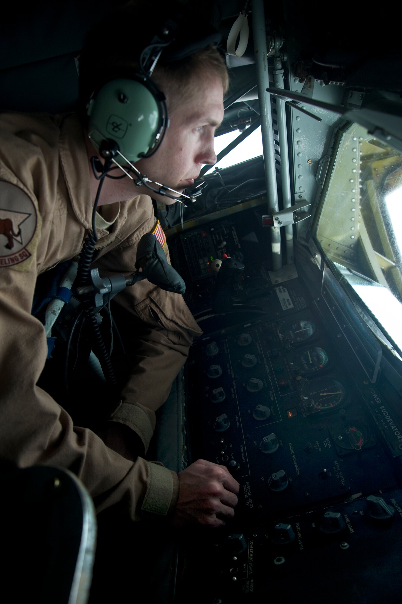 Staff Sgt. Jon Fleming operates the boom on a KC-135 Stratotanker April 9, 2012, during an aerial refueling delivering 85,000 pounds of fuel to a B1-B Lancer over Afghanistan. Fleming is a 22nd Expeditionary Air Refueling Squadron KC-135 boom operator deployed to the Transit Center at Manas, Kyrgyzstan, from March Air Reserve Base, Calif. (U.S. Air Force photo/Staff Sgt. Angela Ruiz)