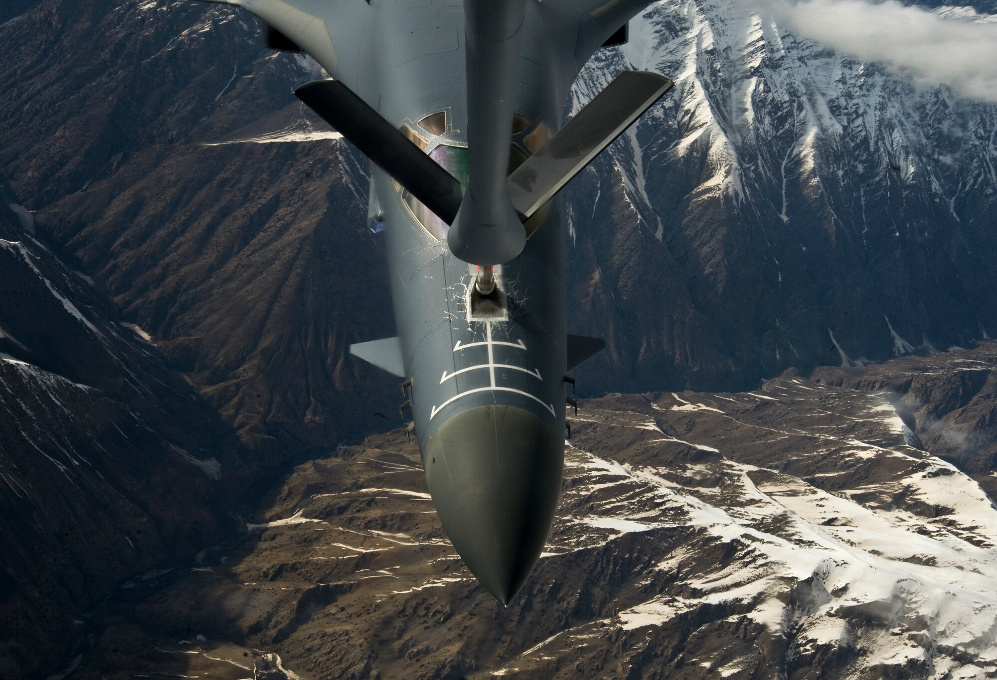 A B1-B Lancer receives fuel from a KC-135 Stratotanker over Afghanistan April 9, 2012. The B1-B Lancer 85,000 pounds of fuel. The Lancer, which is 146 feet long and 34 feet tall, is deployed from Dyess Air Force Base, Texas. The KC-135 Stratotanker is assigned to the Transit Center at Manas, Kyrgyzstan, and is deployed from McConnell AFB, Kan. (U.S. Air Force photo/Staff Sgt. Angela Ruiz)