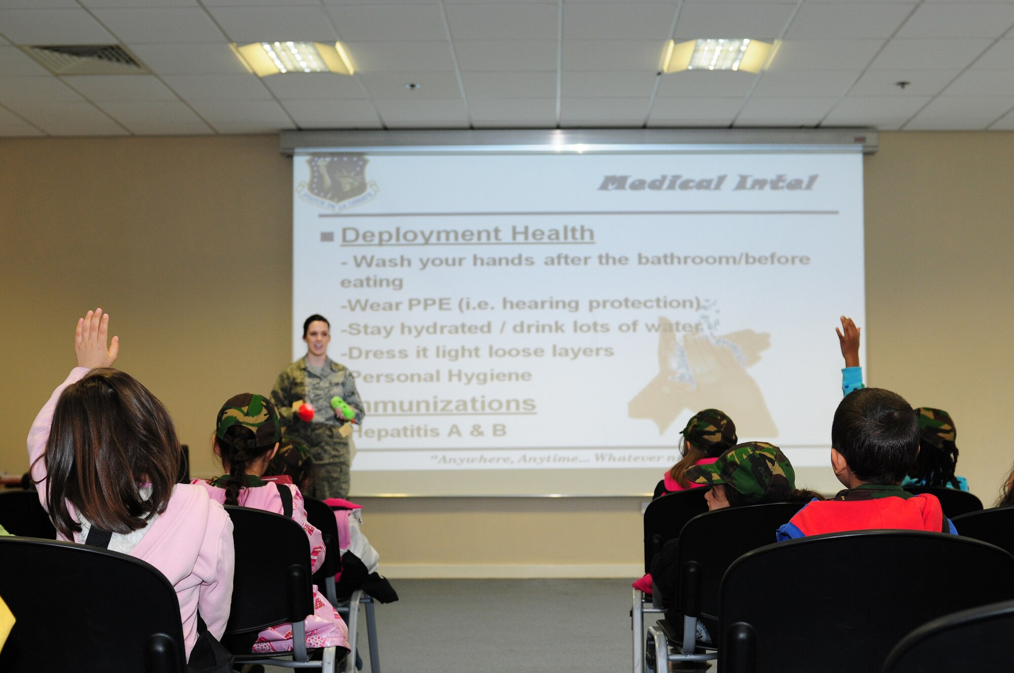 ROYAL AIR FORCE LAKENHEATH, England – Children from Lakenheath Elementary School answer questions during a simulated pre-deployment briefing at the Installation Deployment Readiness Center April 13, 2011. The mock deployment line is designed to provide children with a better understanding of what their parents experience as they prepare for deployment. (U.S. Air Force photo by Airman 1st Class Cory D. Payne)