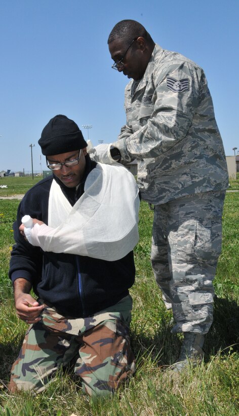 Tech. Sgt. Matthew Dekeyser, 512th Aerospace Medicine Squadron medical readiness technician, treats simulated-wounded patient Master Sgt. Sean Dial, also a medical readiness technician with the squadron, during a mass casualty exercise at Dover Air Force Base, Del., April 13, 2012. (U.S. Air Force photo by Capt. Marnee A.C. Losurdo)