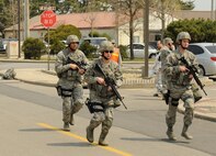 Airmen from the 8th Security Forces Squadron respond to a simulated active shooter as part of an emergency management exercise on Kunsan Air Base, Republic of Korea, April 16, 2012. The 8th Fighter Wing is currently undergoing a Consolidated Unit Inspection by the Pacific Air Forces Inspector General team, who test the base’s ability to respond to crises such as an active shooter.  (U.S. Air Force photo/Senior Airman Jessica Hines)