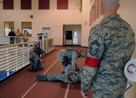 An 8th Fighter Wing exercise evaluation team member observes 8th Security Forces Squadron Airmen as they asses the condition of a simulated victim during an active shooter exercise at the Wolf Pack Fitness Center, April 16, 2012. The 8th Fighter Wing conducted the scenario as part of an ongoing Pacific Air Forces Inspector General Consolidated Unit Inspection. (U.S. Air Force photo/Senior Airman Jessica Hines) 