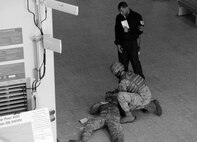 An 8th Fighter Wing exercise evaluation team member observes an 8th Security Forces Squadron Airman as he assists a simulated gunshot victim at the Wolf Pack Fitness Center, April 16, 2012. The Pacific Air Forces Inspector General team is currently conducting inspections of the 8th Fighter Wing to evaluate processes and the Wolf Pack’s ability to react in crisis situations. (U.S. Air Force photo/Senior Airman Jessica Hines) 