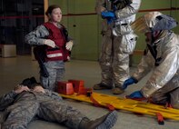 Emergency response Airmen from the 8th Medical Group and the 8th Civil Engineer Squadron Fire Department prepare to transport a simulated gunshot victim at the Wolf Pack Fitness Center, April 16, 2012. The 8th Fighter Wing is currently undergoing a Consolidated Unit Inspection by Pacific Air Forces Inspector General team members, who test the base’s ability to respond to crisis situations such as an active shooter. (U.S. Air Force photo/Senior Airman Jessica Hines) 