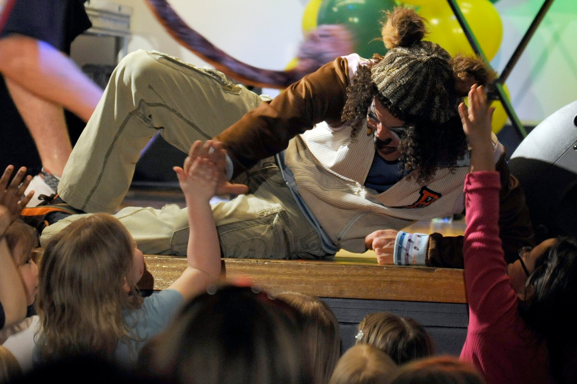 Brandon the Bear gives a child a high-five during The Party Animals live show at Misawa Air Base, Japan, April 15, 2012. Prior to the show, children waited to have their faces painted and have a balloon artist create a balloon figure of their choice. The Party Animals performed at Misawa Air Base as part of an Armed Forces Entertainment show for The Month of the Military Child. (U.S. Air Force photo by Tech. Sgt. Marie Brown/Released)
