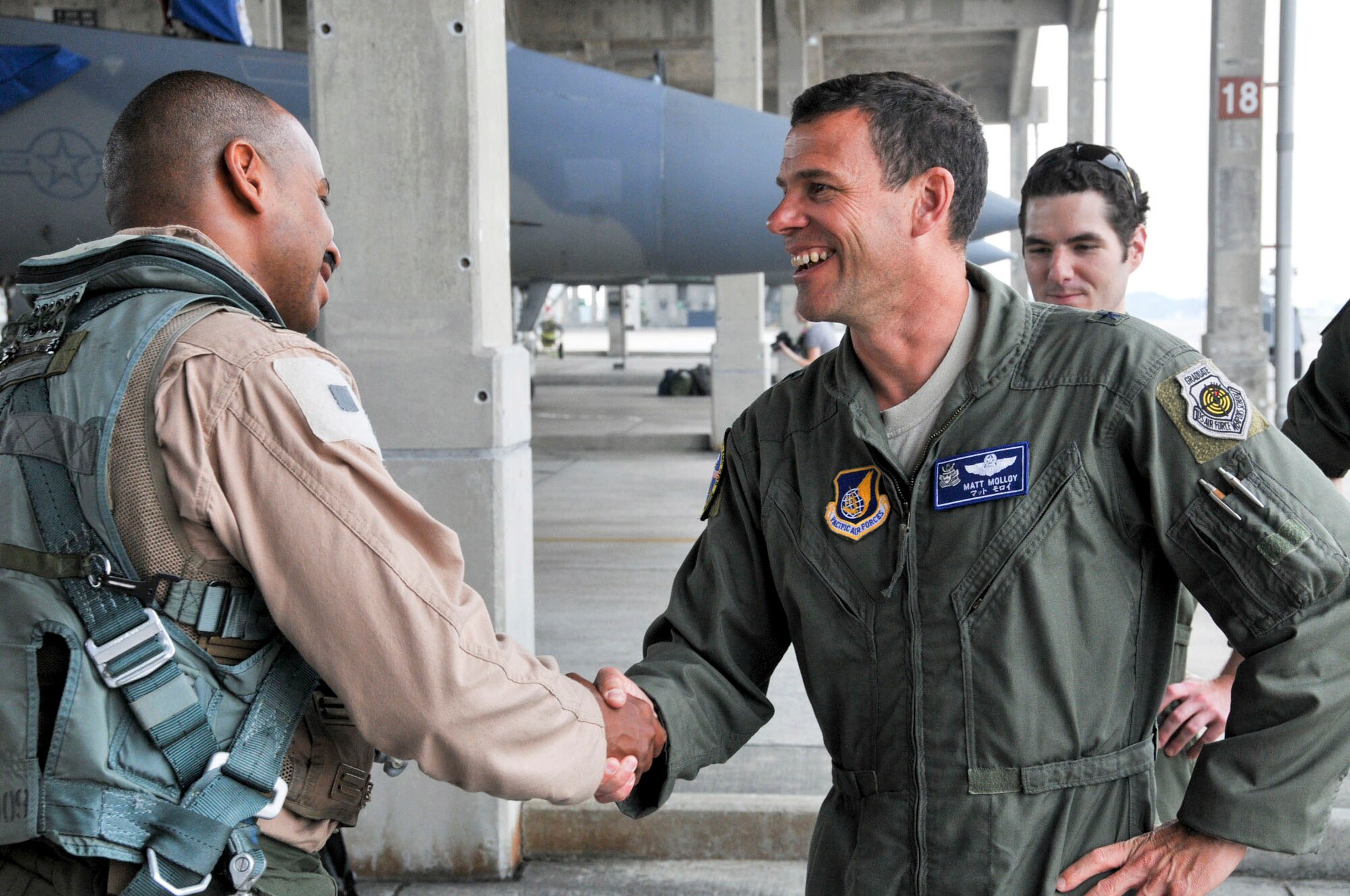 U.S. Air Force Capt. Jon O'rear, 44th Fighter Squadron pilot, is welcomed home by U.S. Air Force Brig. Gen. Matt Molloy, 18th Fighter Wing commander, after returning from a deployment April 12, 2012. The 44th Fighter Squadron returned home and was greeted by friends and family. (U.S. Air Force photo/Staff Sgt. Darnell T. Cannady/Released)