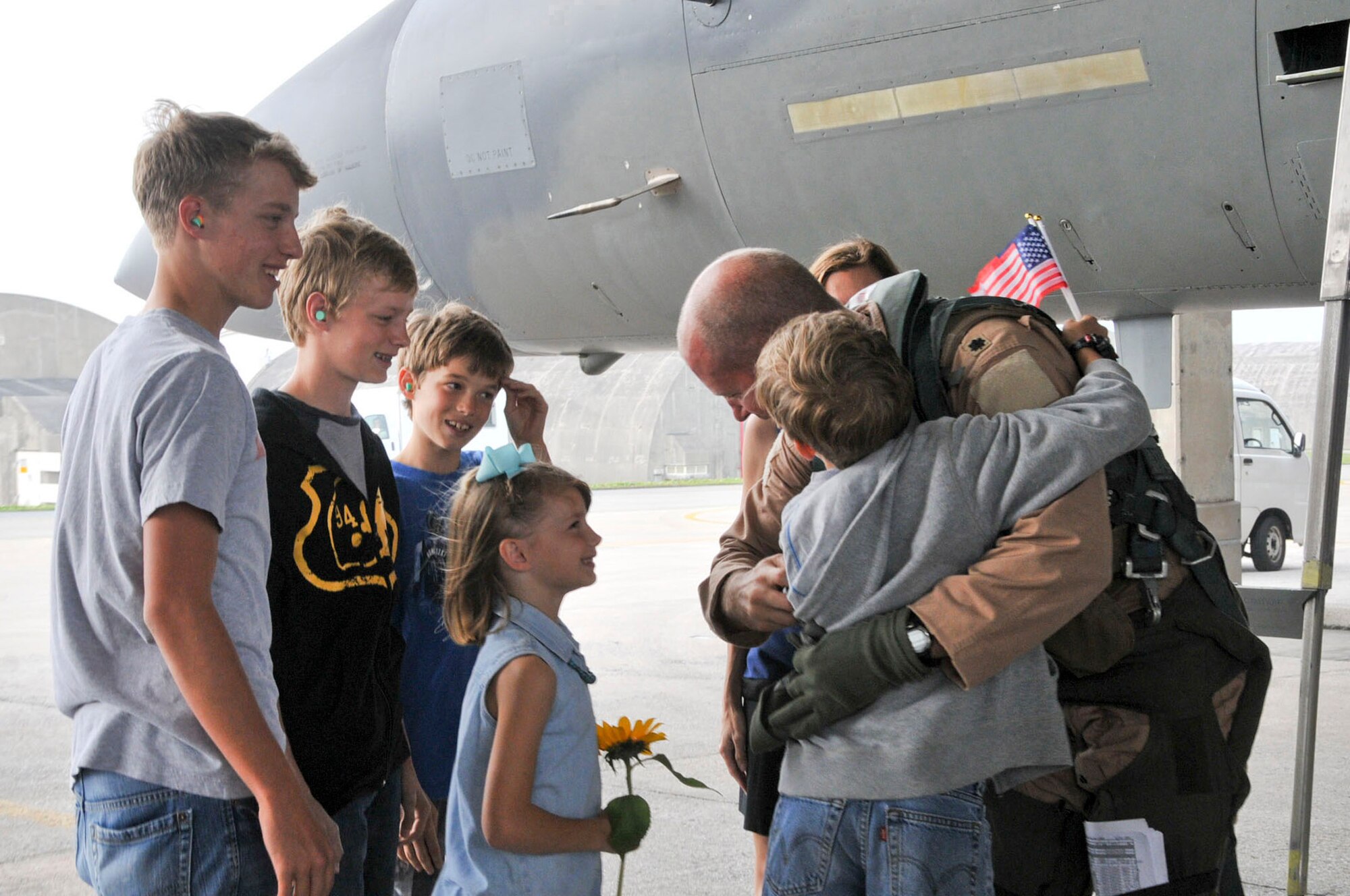 U.S. Air Force Lt. Col. Joel Carey, 44th Fighter Squadron commander, is reunited with his family after returning home from a deployment April 12, 2012, at Kadena Air Base. The 44th Fighter Squadron returned home and was greeted by family and friends. (U.S. Air Force photo/Staff Sgt. Darnell T. Cannady/Released)