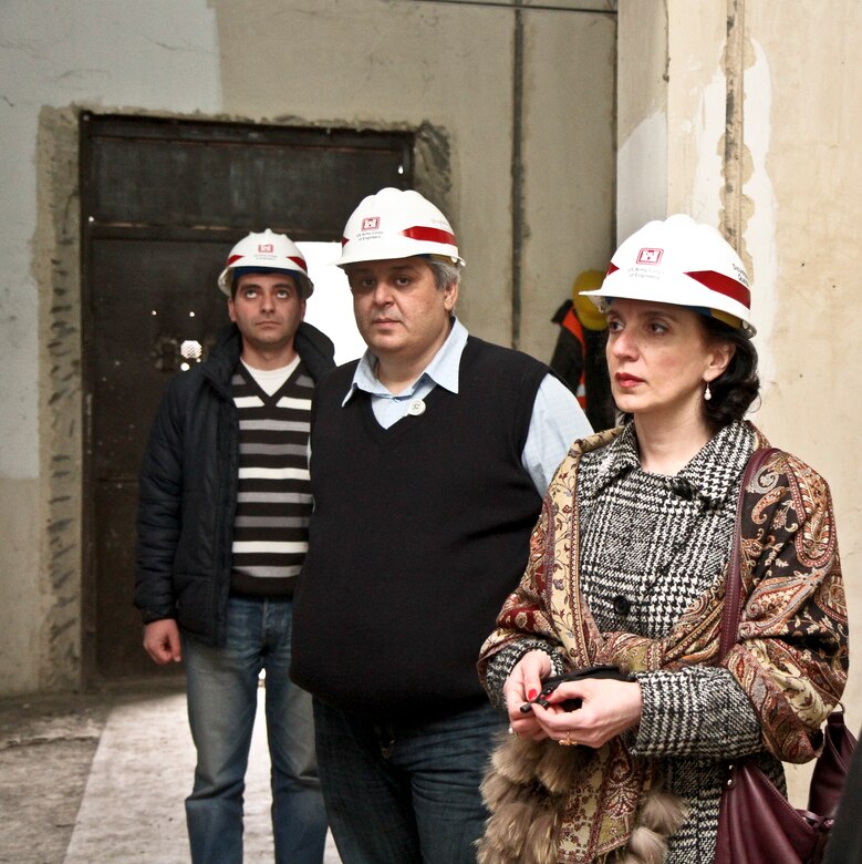 TBLISI, Republic of Georgia — During a recent commander's visit to the Caucasuses, George Shikhiashvili (left), resident office driver and administrative assistance, Shalva Khvadagadze, quality assurance engineer, and Nana Kacheishvili, program coordinator, tour the approximately $1.6 million renovation site of the pathology lab.