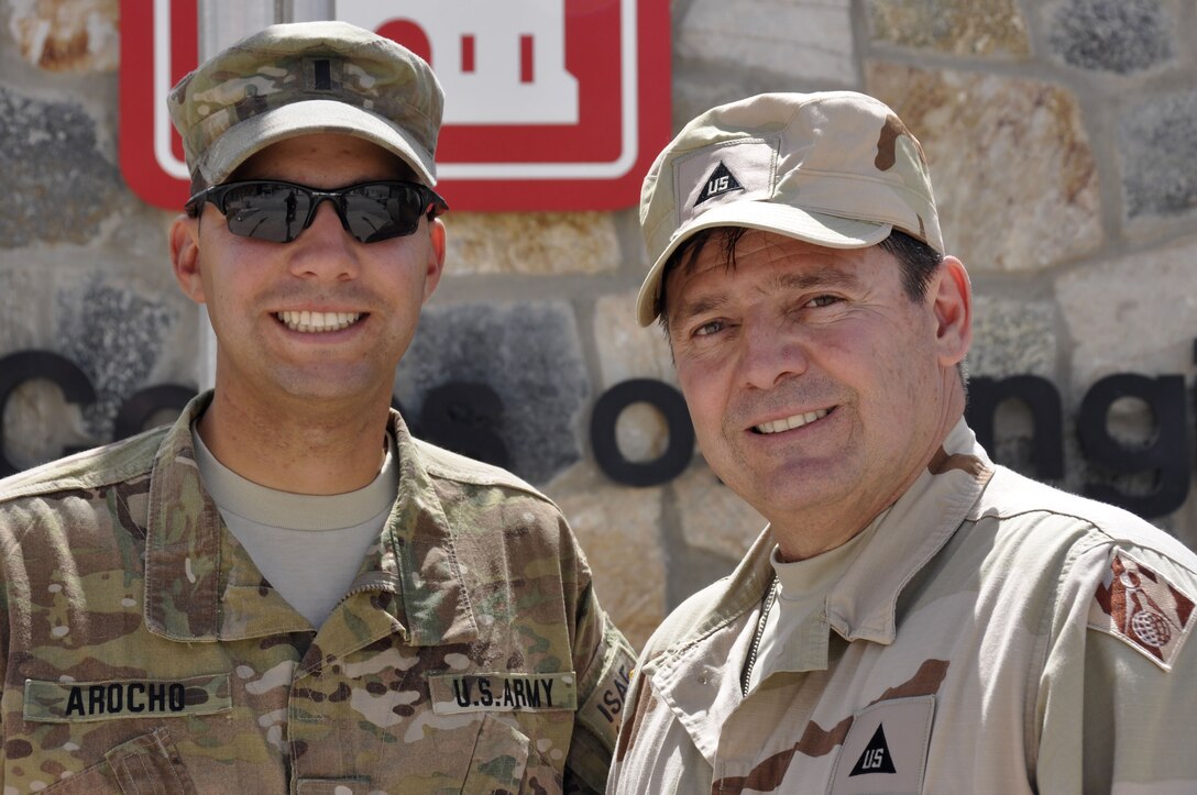 KANDAHAR AIRFIELD, Afghanistan — Julio (right), and 1st Lt. Francisco Arocho, father and son, reunite here, April 15, 2012. Both are currently deployed to Afghanistan; Julio with the U.S. Army Corps of Engineers and Francisco with the 668th Engineer Company from Orangeburg, N.Y