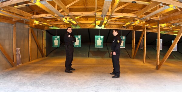 TBLISI, Republic of Georgia — Capt. Besik Galuashvili and Lt. Oniari Gia, instructors at the Tbilisi Police Academy, await cadets to arrive in the 554 square-meter range. The range has movable targets, a modular bullet trap and containment system that allow the bullet casings to be recycled.