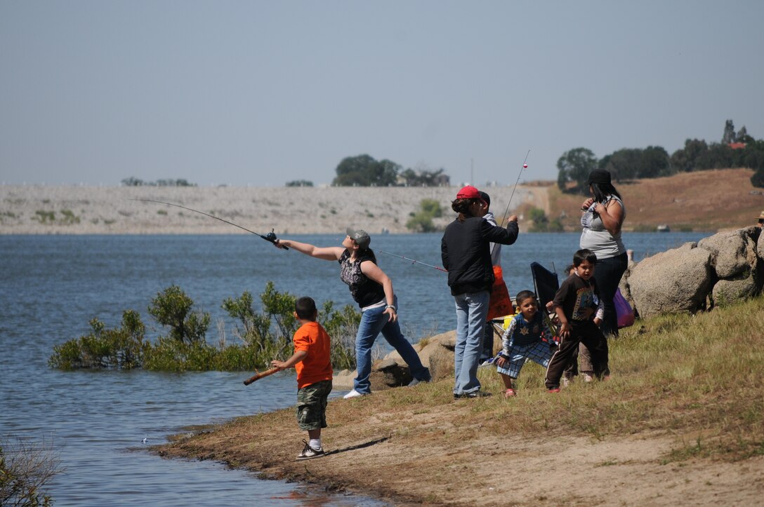 Families enjoy a day of fishing at the lake during the 15th annual Kids Fishing Day.