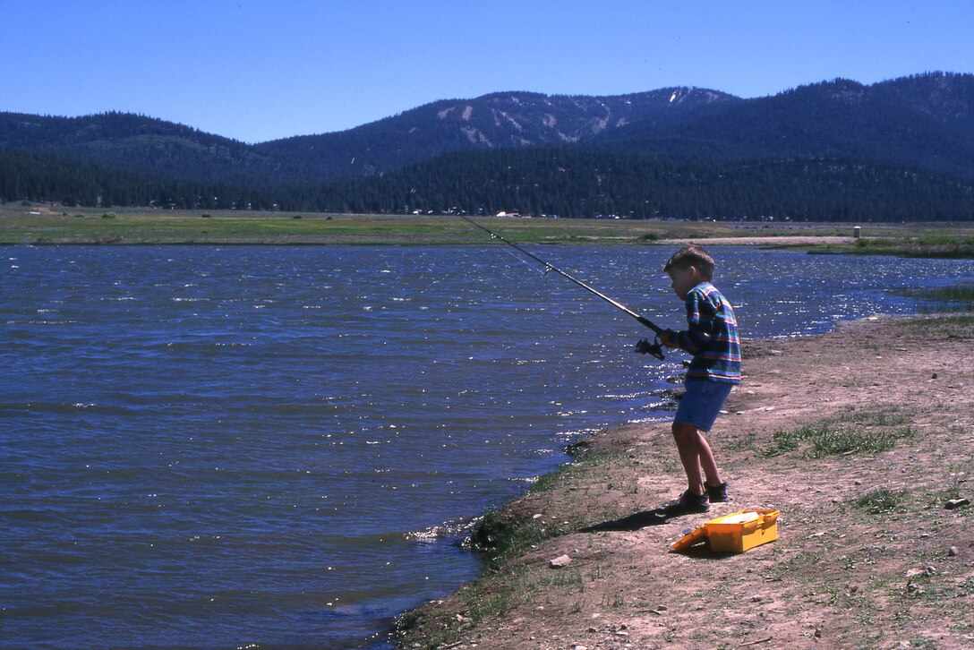 A young fisherman tries his luck at beautiful Martis Creek Lake.