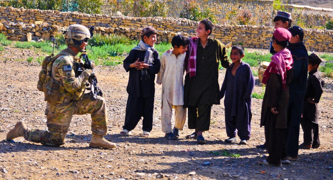 U.S. Army Staff Sgt. Christian Aleman speaks with Afghan children while on patrol on Forward Operating Base Salerno, Afghanistan, April 7, 2012. Aleman, a squad leader, is assigned to A Battery, 2nd Battalion, 377th Parachute Field Artillery Regiment.