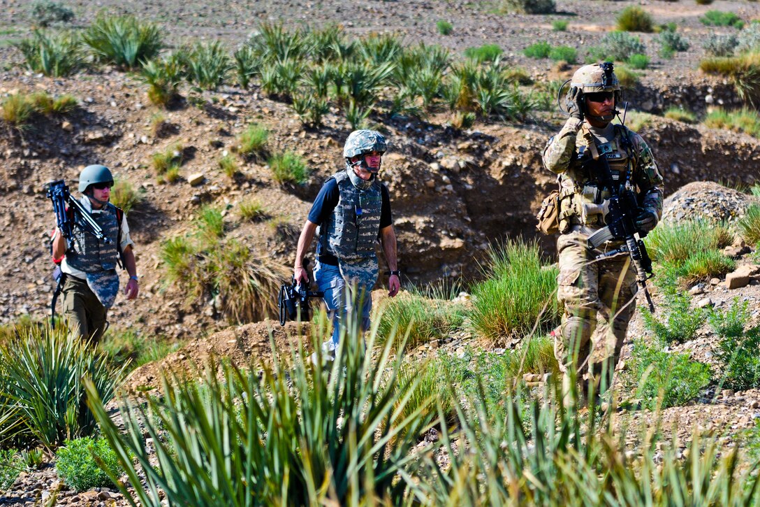 U.S. Army Staff Sgt. Christian Aleman escorts a team of embedded reporters from Anchorage, Alaska, while on patrol on Forward Operating Base Salerno, Afghanistan, April 7, 2012. Aleman, a squad leader, is assigned to A Battery, 2nd Battalion, 377th Parachute Field Artillery Regiment.